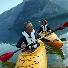 a man and a woman in yellow kayaks