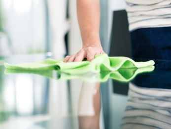 Coast 2 Coast Restorations technician wiping down a countertop with professional cleaning products for odor removal and sanitization in Central Florida