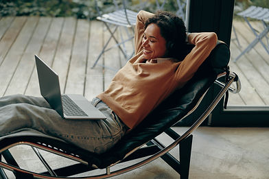 smiling-female-freelancer-working-laptop-remotely-2024-01-02-19-20-30-utc.jpg