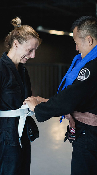 Brazilian Jiu-Jitsu grading and promotion ceremony. Student awarded their Blue Belt.