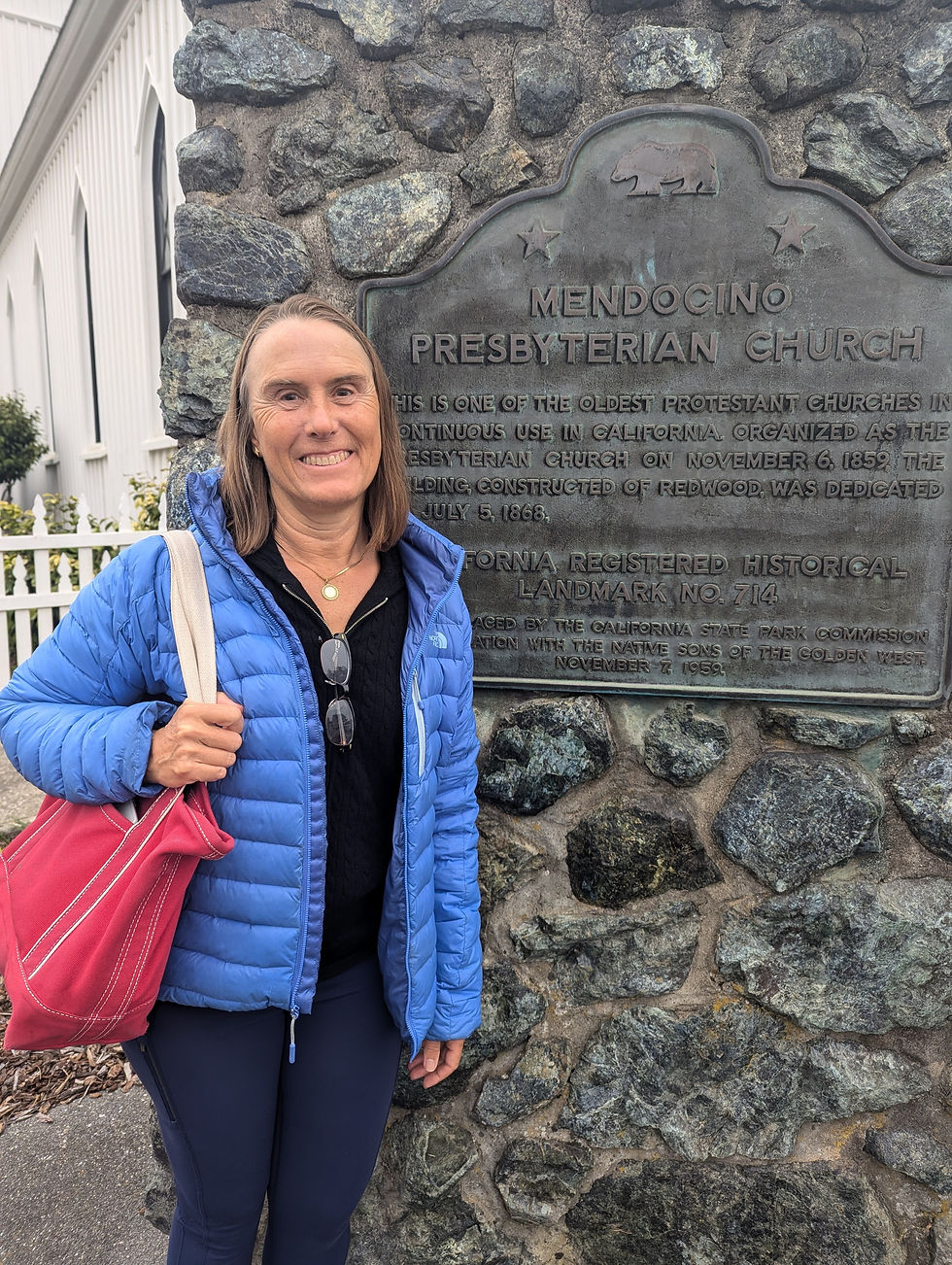 Debbie in front of the historic market at Mendocino Presbyterian Church