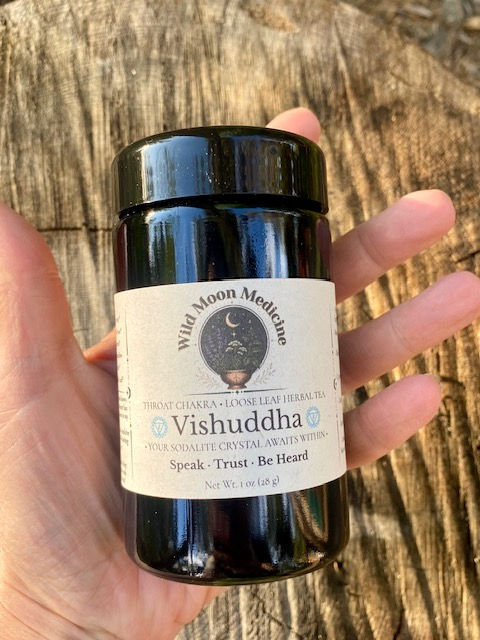 Thumbnail: Hand holding Wild Moon Medicine Vishuddha Throat Chakra Tea 1 oz Miron jar