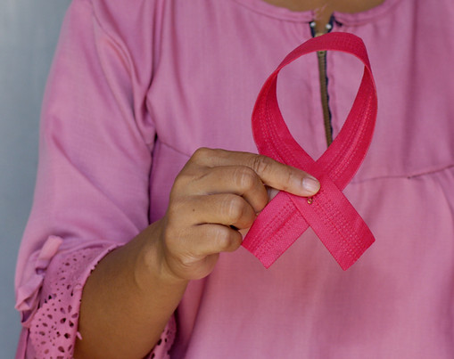 Woman holding a pink ribbon as an awaren