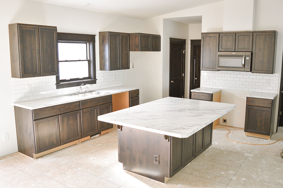Wardcraft Homes Stone colored kitchen in Jamestown floorplan.