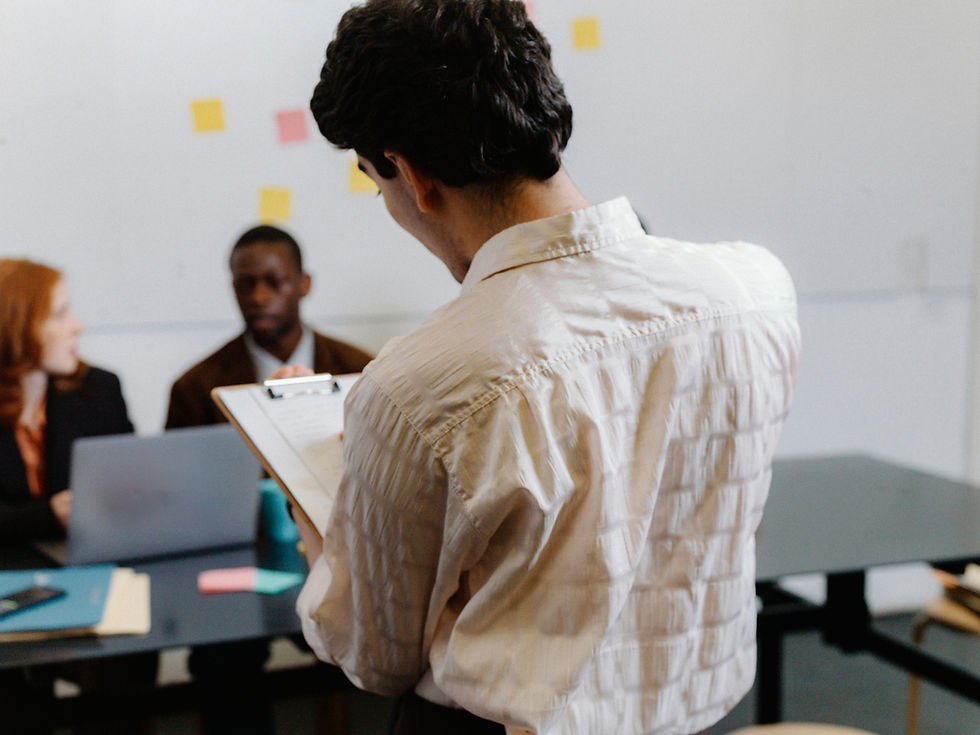 A spotlighted presenter pitching to a group of executives