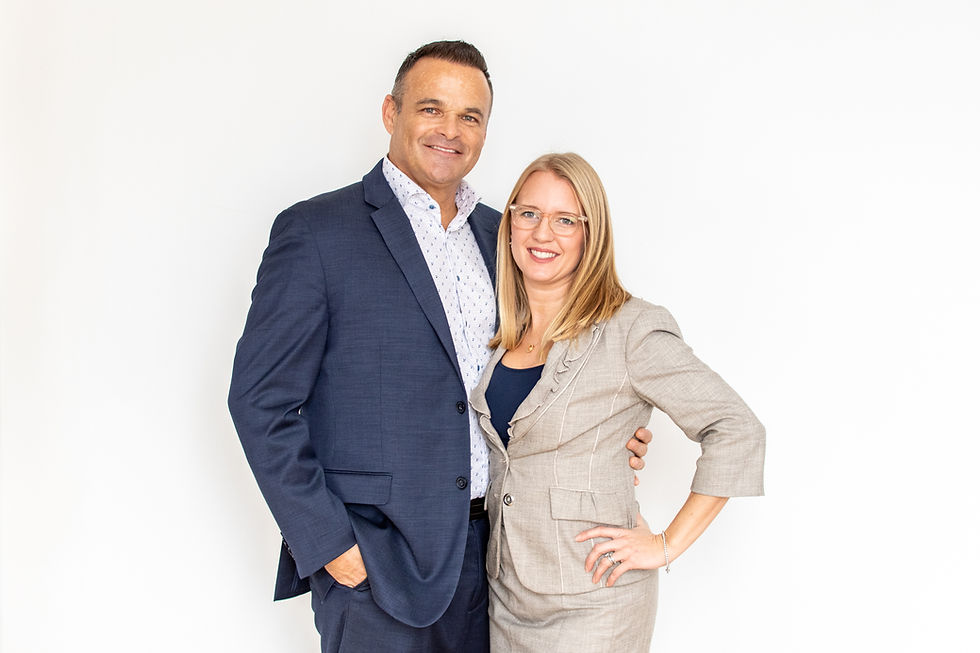 Dan Plowman smiling confidently in a professional setting, representing experience and leadership in real estate coaching.