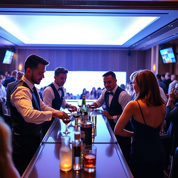 4 bartenders at a corporate event. bright backdrop, square bar. lots of guest with a fe