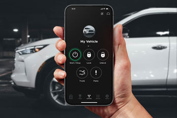 Driver using DroneMobile app on smartphone to start a vehicle remotely