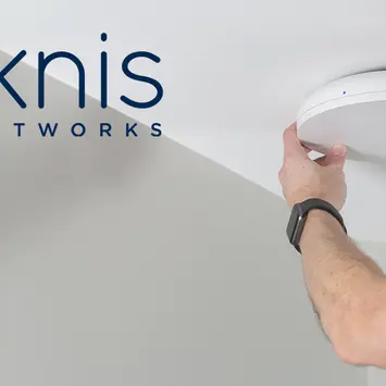 Close-up of Araknis wireless access point mounted on a ceiling