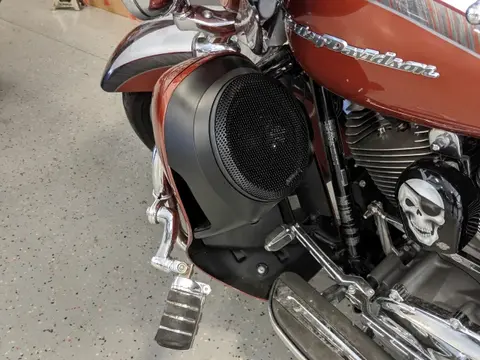Sound FX technician installing weather-resistant motorcycle speakers