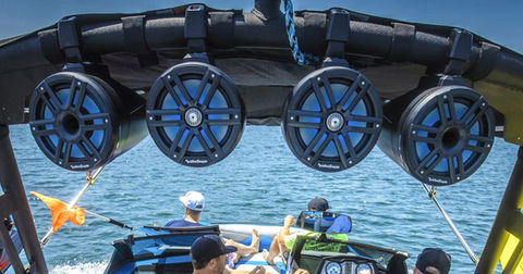 Boat equipped with upgraded marine speakers playing music on the lake