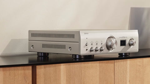 Close-up of Denon integrated amplifier with brushed aluminum finish
