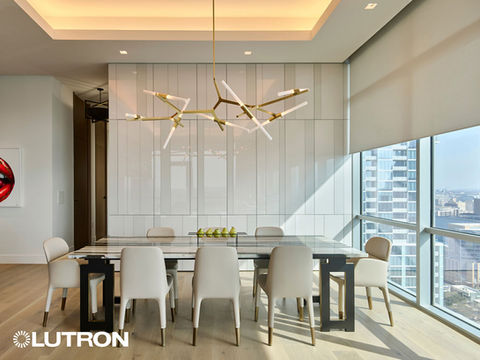 Elegant dining room with Lutron lighting system creating a warm atmosphere