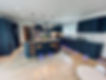 A stunning and modern kitchen renovation using Navy blue vinyl wraps on the units, and blue marble worktops.