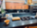 A fully vinyl wrapped kitchen with a mixture of deep blue and natural wood effects.
