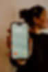 woman holding phone, showing BILY calling