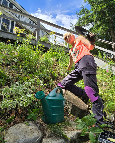 woman plants on a hillside