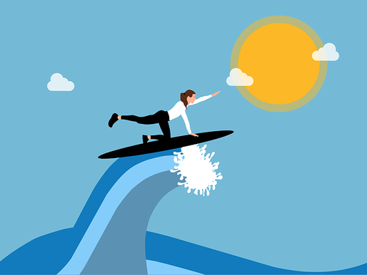 A woman is riding a wave while reaching for the sun