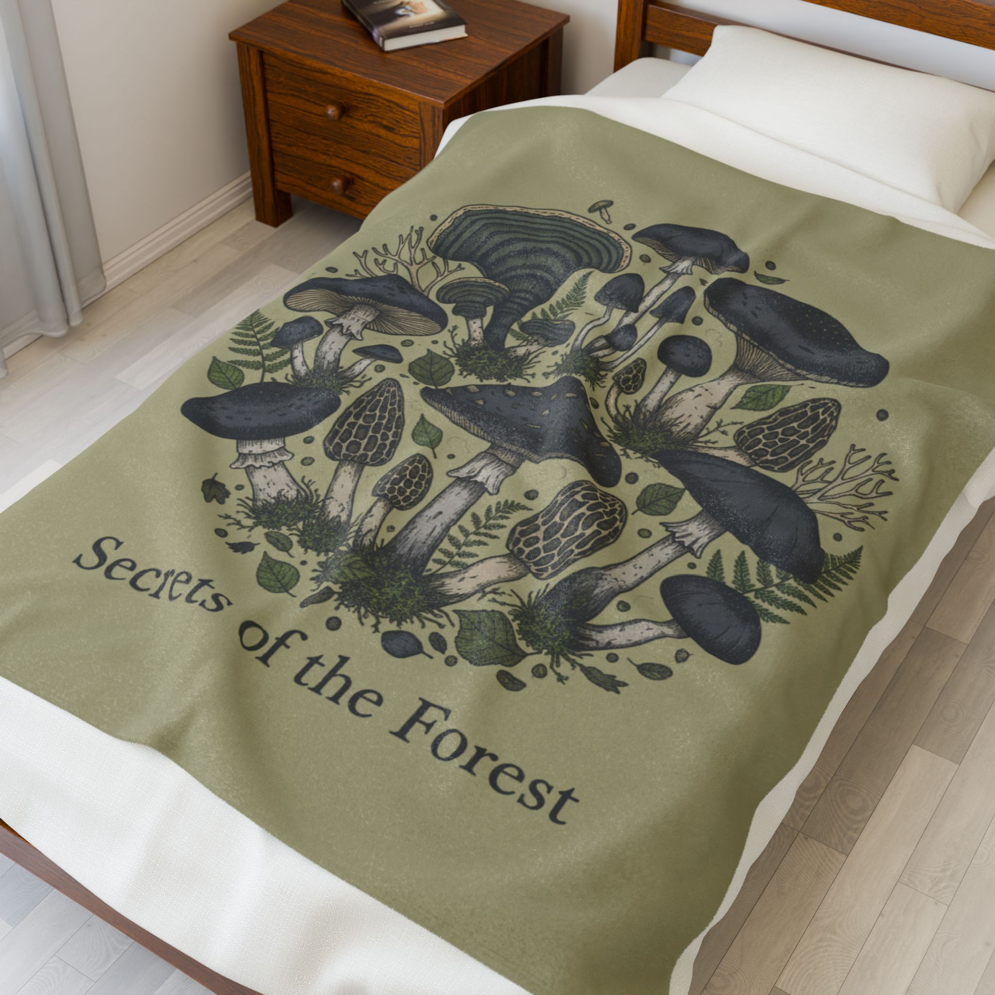 Earthy great velveteen blanket with a variety of mushrooms text Secrets of the Forest under image on a bed