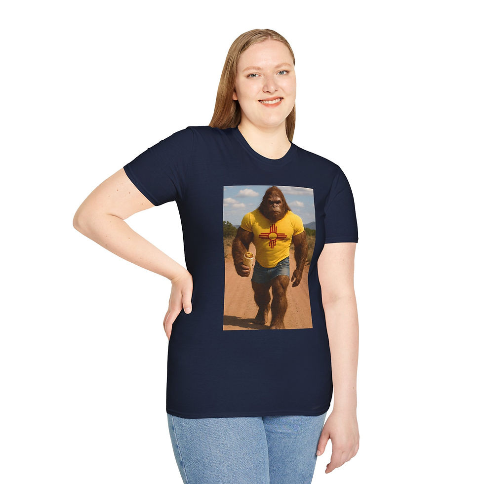 Thumbnail: large muscular Bigfoot in the desert wearing a yellow with red Zia symbol on a t-shirt