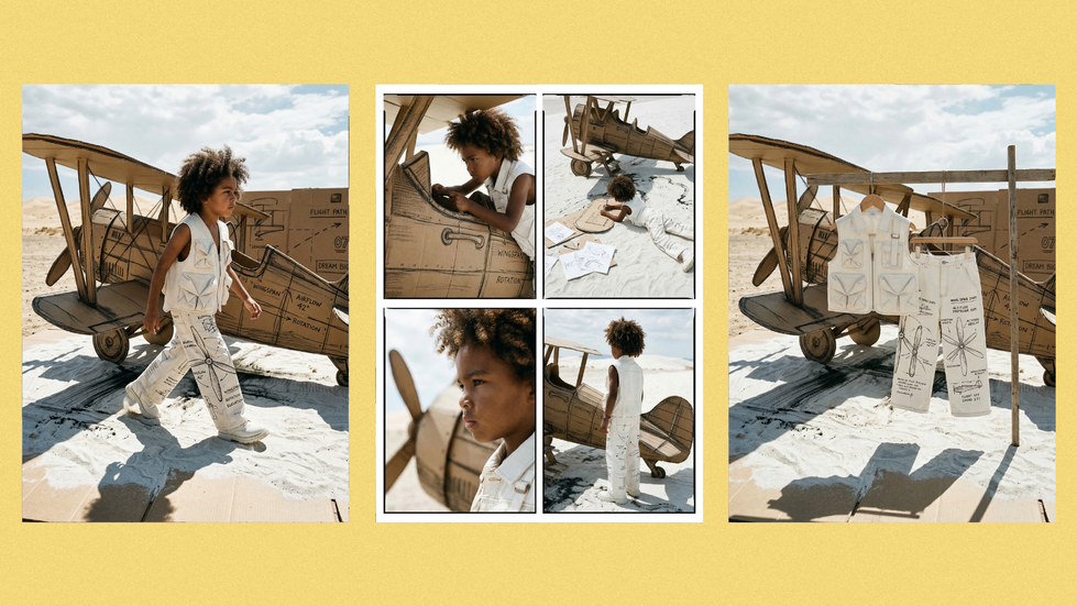 Child playing with wooden airplane on sandy beach.