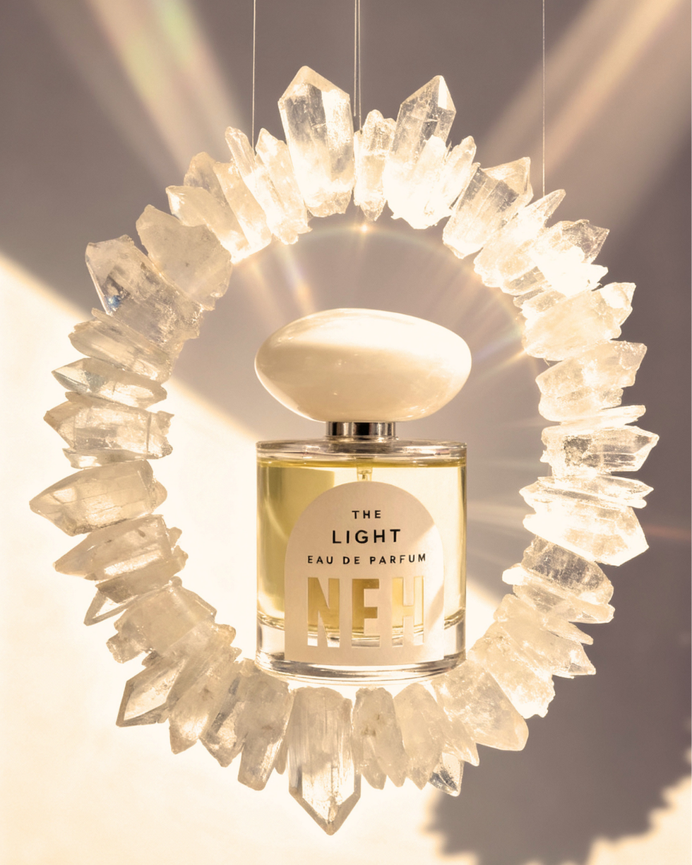 Perfume bottle surrounded by crystal-like formations.