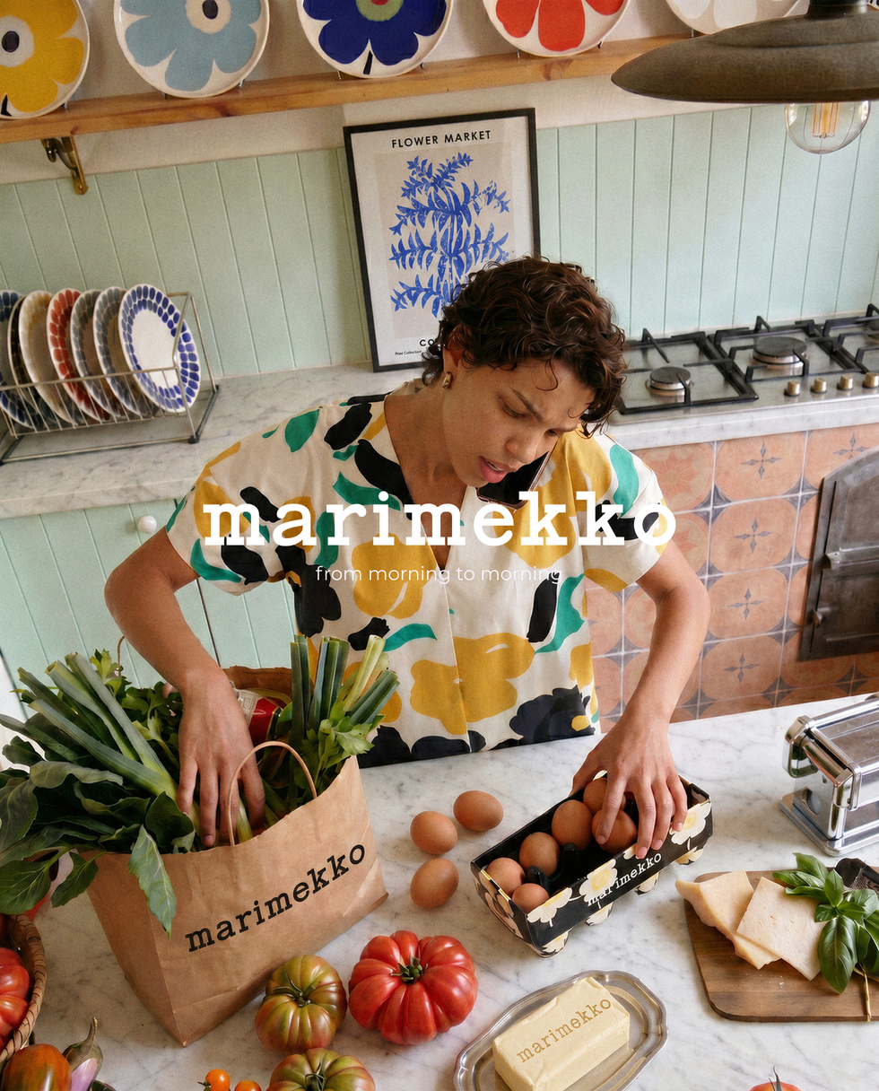 Person unpacking groceries in a kitchen.