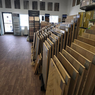 A detailed view of a large hardwood flooring display section at Harry's Carpets.