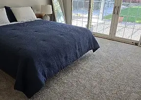 Stanton textured bedroom carpet installation in Green Valley by Harry's Carpets.