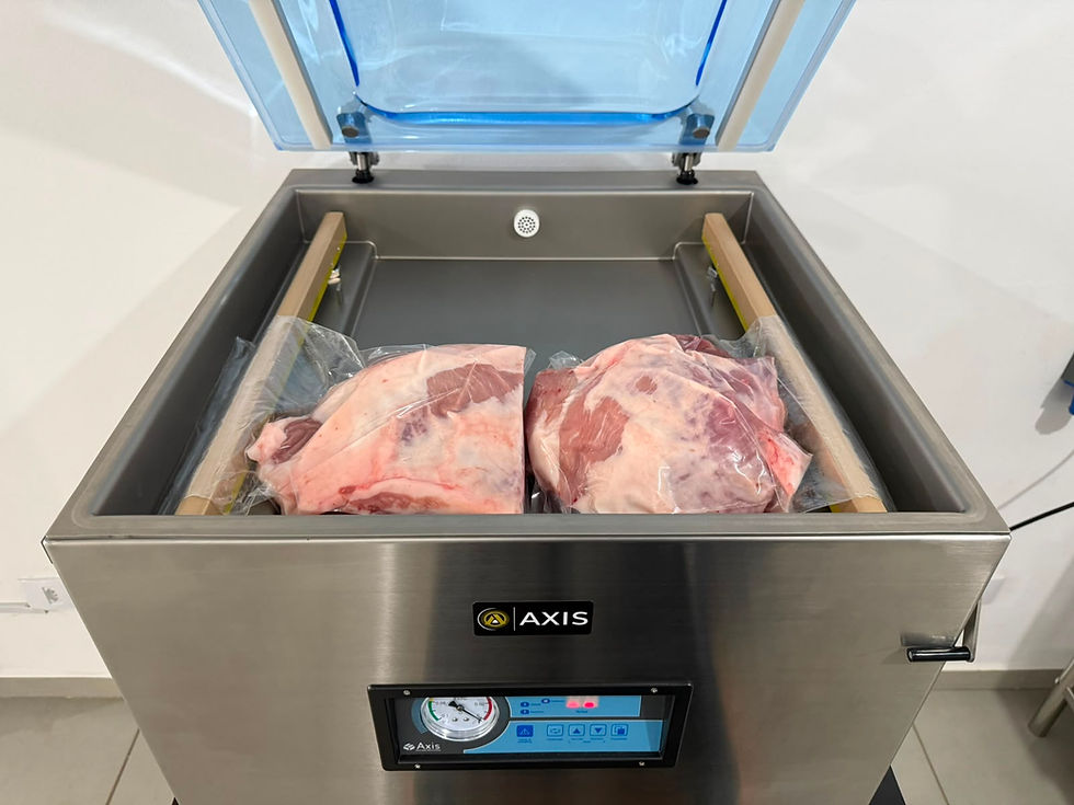 Câmara a vácuo de aço inox AXIS com dois cortes de carne embalados, tampa azul aberta em ambiente limpo e clínico.