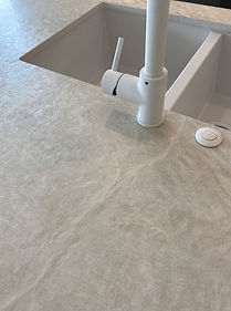 cream stone bechtop dekton liquid shell with white tapware and white airswitch botton