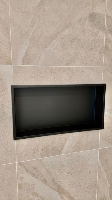 Black wall niche integrated into a shower