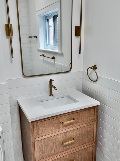 Wood and brass vanity in a renovated Montreal bathroom | BonBain