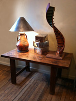 Wooden table with lamp, boxes, and sculpture; antique furniture modern classic