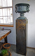 Ornate bronze urn on pedestal