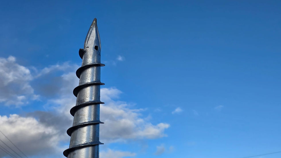 A photo of the tip of a ground screw against the backdrop of a dramatic blue sky