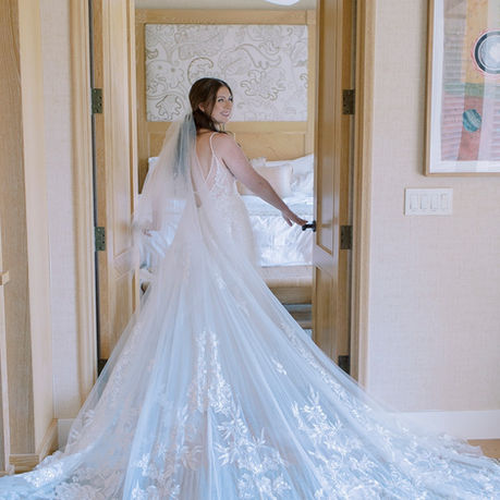 Bride wearing lace wedding gown and veil at Auberge du Soleil Napa Valley with hair and makeup by AN Artistry.