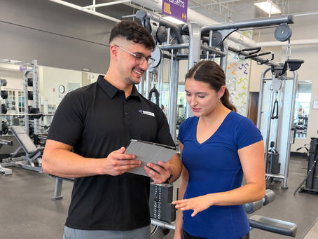 Personal trainer discussing a custom training plan with a client at Starck Fitness in Naperville.