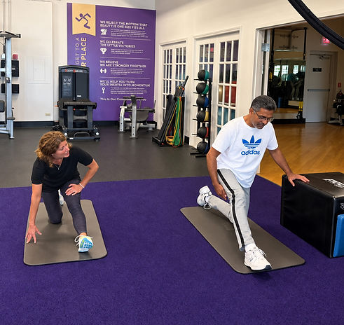 Mobility trainer coaching a client through a hip-flexor stretch during 1-on-1 training at Starck Fitness in Naperville.