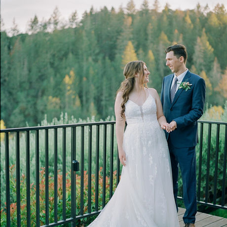 Bride and groom on terrace at Auberge du Soleil Napa Valley with hair and makeup by AN Artistry mobile beauty team.