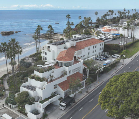 Aerial view of tile roofing job with Laguna Beach coast in the background