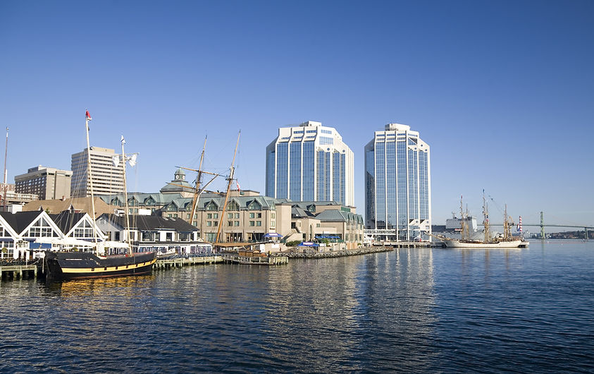 Tall ships docked in the early morning on Halifax's waterfront at Purdy's Wharf and farthe