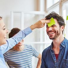 Man with note on forhead at creative wor