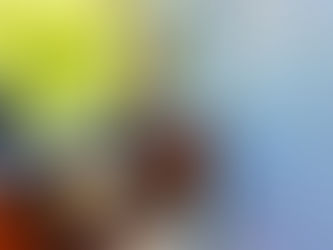 Person in orange gloves using a caulk gun on a window frame, with a blurred green outdoor background, creating a focused, work environment.