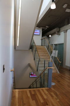 Staircase with TV installation on wall