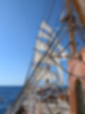Sea Cloud Spirit sailing under full sail off the coast of Sicily