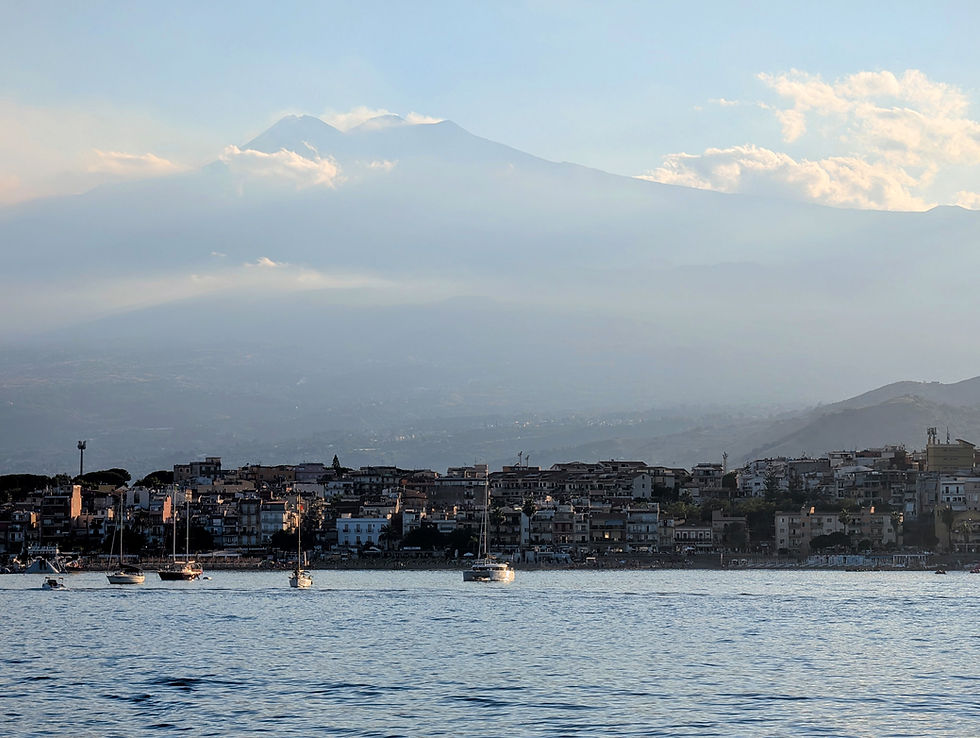 Mount Etna looms above Giardina Naxos in Sicily