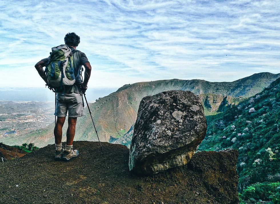 A hiker looks out across Gran Canaria from one of the islands highest peaks