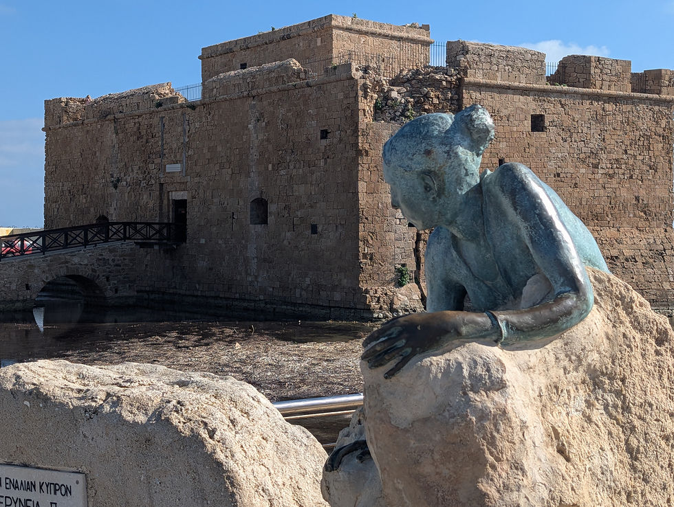 Status and old fort in the harbour at Paphos, Cyprus