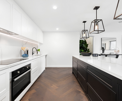 Modern kitchen with island bench, pendant lighting and herringbone timber flooring